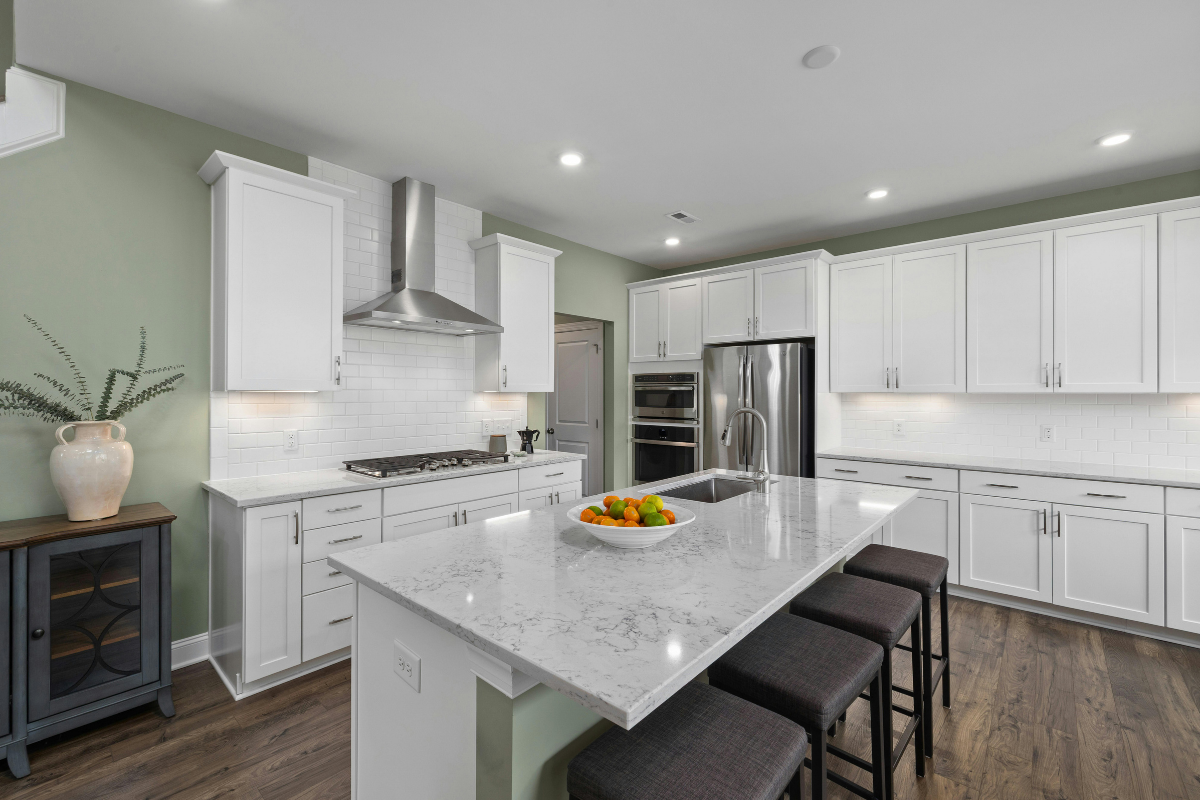 High-end white kitchen with large island and modern finishes